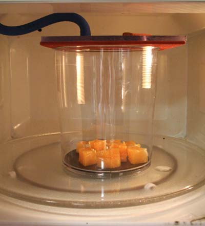 Interior of the vacuum microwave with chunks of orange