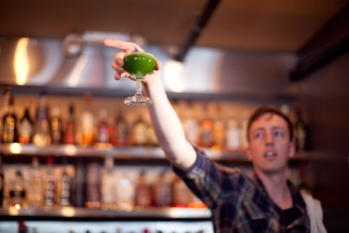 Bar manager Tristan shows off the greenness of the Bangkok Daiquiri. Pretty photo by Shannon Sturgis for StarChefs
